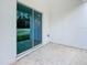 Covered patio with a large glass sliding door leading to the backyard with green grass and trees at 8258 Sw 136Th Ter, Dunnellon, FL 34432