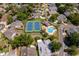 Aerial view of the community featuring a pool, tennis court, and many trees at 849 Millrace Pt, Longwood, FL 32750