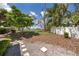 Lush backyard with mature trees, a white fence, and gravel walkway at 849 Millrace Pt, Longwood, FL 32750