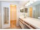 Bathroom with vanity and closet featuring sliding mirror doors at 849 Millrace Pt, Longwood, FL 32750