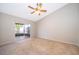 Bedroom with neutral carpet and sliding glass doors to a screened-in patio at 849 Millrace Pt, Longwood, FL 32750