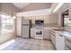 Open kitchen layout with bright white appliances and plenty of natural light at 849 Millrace Pt, Longwood, FL 32750