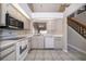 Kitchen with tile floors, white appliances, and a view into the dining area at 849 Millrace Pt, Longwood, FL 32750