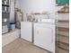Functional laundry room with washer, dryer, and shelving for storage at 849 Millrace Pt, Longwood, FL 32750