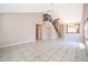 Open-concept living room with tile flooring, high ceilings, and staircase to the second floor at 849 Millrace Pt, Longwood, FL 32750