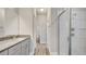 Bright bathroom with granite vanity, tile shower, and wood vinyl flooring offering a clean, modern look at 8560 Magnificent Ln, Groveland, FL 34736