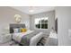 Inviting bedroom with stylish decor, a large window, and a ceiling fan at 8560 Magnificent Ln, Groveland, FL 34736