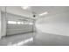 Spacious two car garage featuring epoxy flooring and overhead lighting at 8560 Magnificent Ln, Groveland, FL 34736