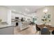 Open-concept kitchen with island seating, stainless steel appliances, and views into the living area at 8560 Magnificent Ln, Groveland, FL 34736
