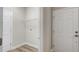 Bright laundry room with wire shelving and light wood vinyl flooring, offering functional storage space at 8560 Magnificent Ln, Groveland, FL 34736