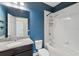 Bathroom featuring granite vanity top, under-mount sink, and tiled shower at 9389 Meadow Hunt Way, Winter Garden, FL 34787