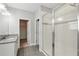 Bright bathroom featuring a single sink with granite countertop, walk-in closet, and walk-in shower at 9389 Meadow Hunt Way, Winter Garden, FL 34787