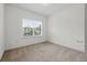 Cozy carpeted bedroom with a large window providing natural light, creating a comfortable and inviting space at 9389 Meadow Hunt Way, Winter Garden, FL 34787
