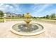 Attractive three-tier fountain feature with stone surround, in a community with well maintained lawns and attractive homes at 9389 Meadow Hunt Way, Winter Garden, FL 34787