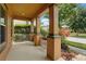 Inviting front porch with classic columns and well-maintained landscaping at 9389 Meadow Hunt Way, Winter Garden, FL 34787