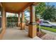 Inviting covered front porch with decorative columns and landscaped garden beds, offering a welcoming curb appeal at 9389 Meadow Hunt Way, Winter Garden, FL 34787