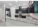 Elegant kitchen featuring granite countertops, stainless steel appliances, and dark wood cabinetry at 9389 Meadow Hunt Way, Winter Garden, FL 34787