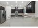 Beautiful kitchen with dark wood cabinets, granite countertops, and stainless steel appliances at 9389 Meadow Hunt Way, Winter Garden, FL 34787