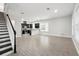 Open concept living room and kitchen with modern gray floors and stainless appliances at 9389 Meadow Hunt Way, Winter Garden, FL 34787