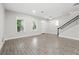 Spacious open-concept living room with natural light and wood-look floors at 9389 Meadow Hunt Way, Winter Garden, FL 34787
