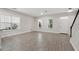 Bright living room featuring tile floors, large windows, and a white front door at 9389 Meadow Hunt Way, Winter Garden, FL 34787