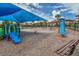 Community playground featuring swings, slides, and shaded seating for families at 9389 Meadow Hunt Way, Winter Garden, FL 34787