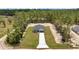 Expansive aerial view of a modern home with large lot and well-maintained lawn nestled near a lush forest at 9695 Sw 125 Court Rd, Dunnellon, FL 34432