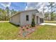 Charming single-story home with gray accents and a well-manicured lawn and landscaping at 9695 Sw 125 Court Rd, Dunnellon, FL 34432
