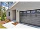 Charming single-story home with gray accents, a gray garage door, and landscaping at 9695 Sw 125 Court Rd, Dunnellon, FL 34432