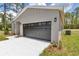 Charming single-story home with gray accents, a gray garage door, and landscaping at 9695 Sw 125 Court Rd, Dunnellon, FL 34432