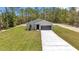Charming single-story home with a long driveway, attached garage, and a nicely landscaped yard at 9695 Sw 125 Court Rd, Dunnellon, FL 34432