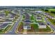 Aerial view of a residential neighborhood with modern homes, green lawns, and a scenic pond at 979 Sun Burst Rd, Winter Haven, FL 33880