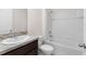 Clean bathroom featuring a shower-tub combo, granite vanity, and tiled walls at 979 Sun Burst Rd, Winter Haven, FL 33880