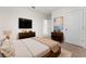 Comfortable bedroom with a large bed, dual nightstands, and dresser with TV at 979 Sun Burst Rd, Winter Haven, FL 33880