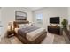 Stylishly designed bedroom with a king bed, modern decor, and plenty of natural light from the window at 979 Sun Burst Rd, Winter Haven, FL 33880
