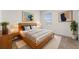 Well-lit bedroom features natural accents, a cozy rug, and a large window at 979 Sun Burst Rd, Winter Haven, FL 33880