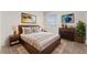Stylish bedroom with a large bed, nightstands, and a window offering natural light at 979 Sun Burst Rd, Winter Haven, FL 33880