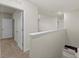 Upstairs hallway with carpet flooring, neutral walls, and access to several rooms at 979 Sun Burst Rd, Winter Haven, FL 33880