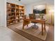 Cozy home office featuring built-in bookshelves, a wooden desk, and a comfortable chair at 979 Sun Burst Rd, Winter Haven, FL 33880