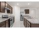 Modern kitchen with granite countertops, stainless steel appliances, and a center island sink at 979 Sun Burst Rd, Winter Haven, FL 33880