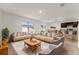 Bright living room with two sofas, plush rug, and open floor plan leading to kitchen and dining area at 979 Sun Burst Rd, Winter Haven, FL 33880