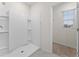 Modern shower with white tile surround and a built-in shelving system at 979 Sun Burst Rd, Winter Haven, FL 33880
