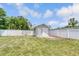 Backyard features a storage building and a fenced perimeter, great for pets and outdoor activities at 99 Eastridge Dr, Eustis, FL 32726