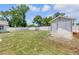 Well maintained backyard with fenced perimeter features a storage shed and green lawn at 99 Eastridge Dr, Eustis, FL 32726