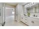Bright bathroom boasts double vanity and glass shower, leading into the bedroom at 99 Eastridge Dr, Eustis, FL 32726