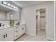 Modern bathroom features a double sink vanity and walk-in closet at 99 Eastridge Dr, Eustis, FL 32726