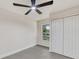 Bedroom with tiled floors, a ceiling fan, closet, and a window with a leafy outdoor view at 99 Eastridge Dr, Eustis, FL 32726