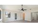 Light-filled bedroom with vaulted ceilings, ceiling fan, and backyard access at 99 Eastridge Dr, Eustis, FL 32726