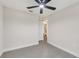 Bedroom showcasing a ceiling fan, with an adjacent bathroom, offering both comfort and convenience at 99 Eastridge Dr, Eustis, FL 32726