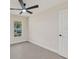 Bedroom featuring a window with outside view, fan and tiled floors at 99 Eastridge Dr, Eustis, FL 32726